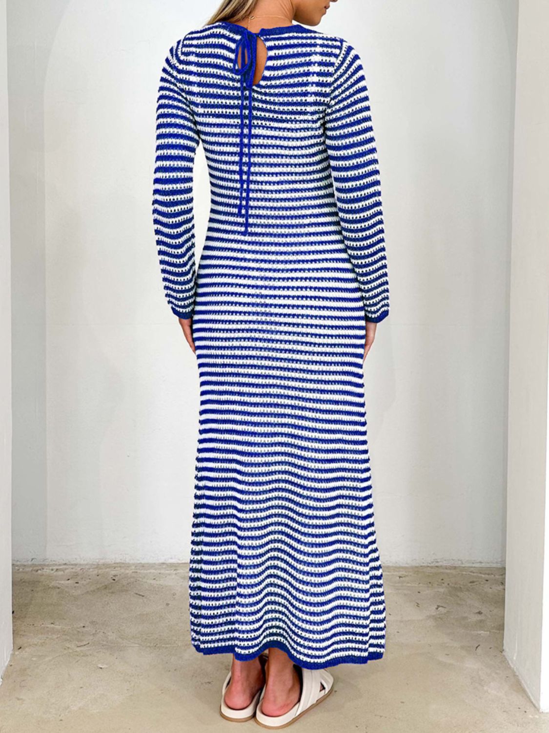 Devine tied round neck striped sweater dress in blue and white, back view.