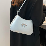 Small bow PU leather knotted strap handbag worn over shoulder.