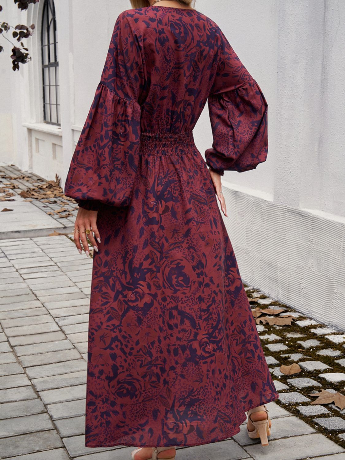 Split printed surplice midi dress with long sleeves and smocked waist in 100% polyester.