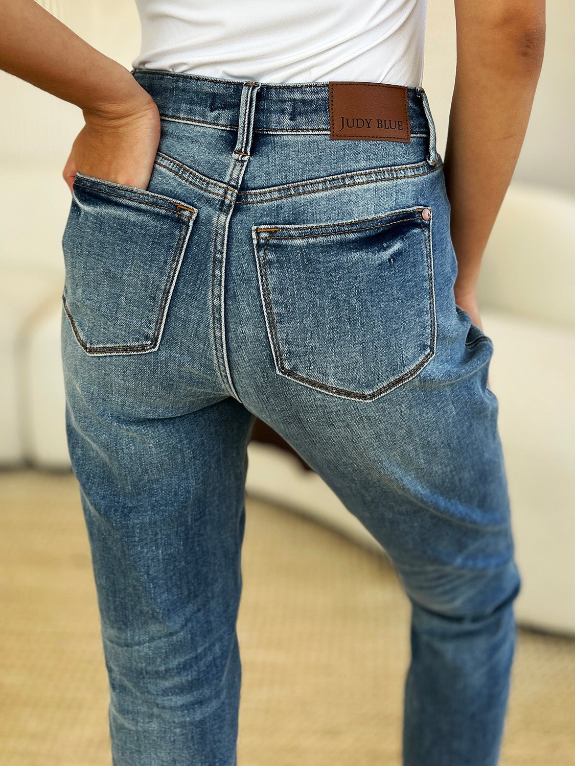 Judy Blue Full Size Mid Rise Magic Release Hem Jeans for women displaying back view with pockets.