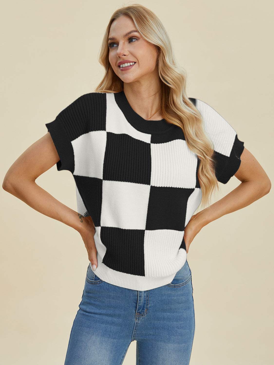 Full size checkered round neck short sleeve sweater in black and white pattern.