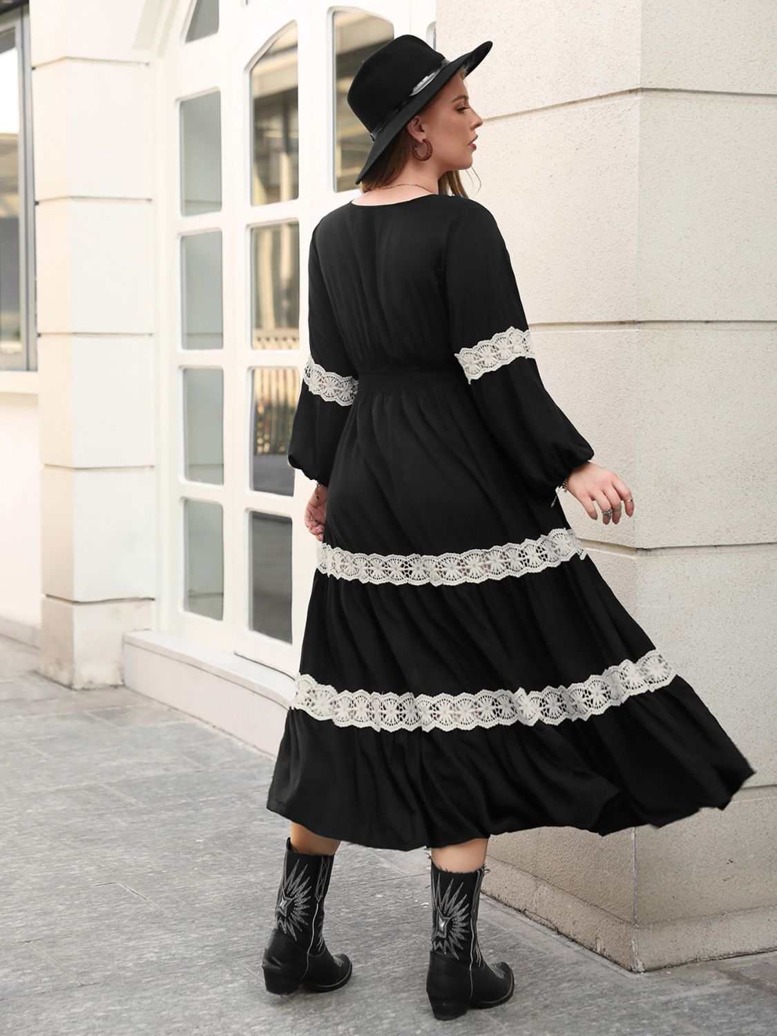 Plus size black midi dress with lace detail, V-neck, and long sleeves.