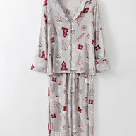 Printed long sleeve top and pants lounge set in gray with red and white holiday motifs.