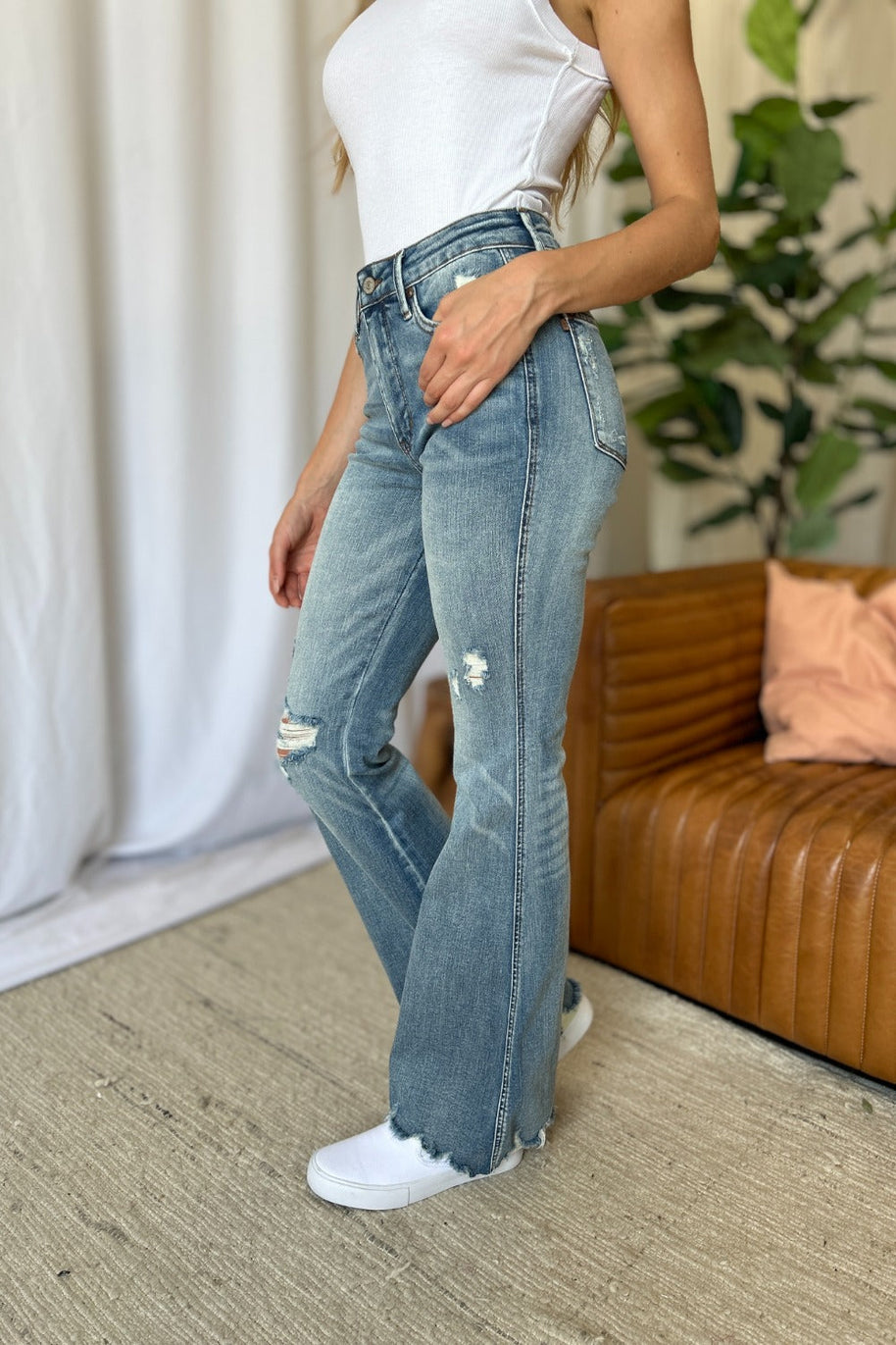 Judy Blue full size medium rise flare jeans with tummy control and distressed detailing.