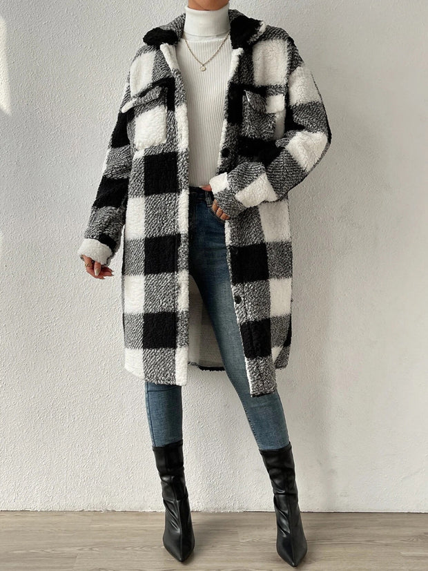 Plaid collared neck button down coat with black and white checkered pattern.