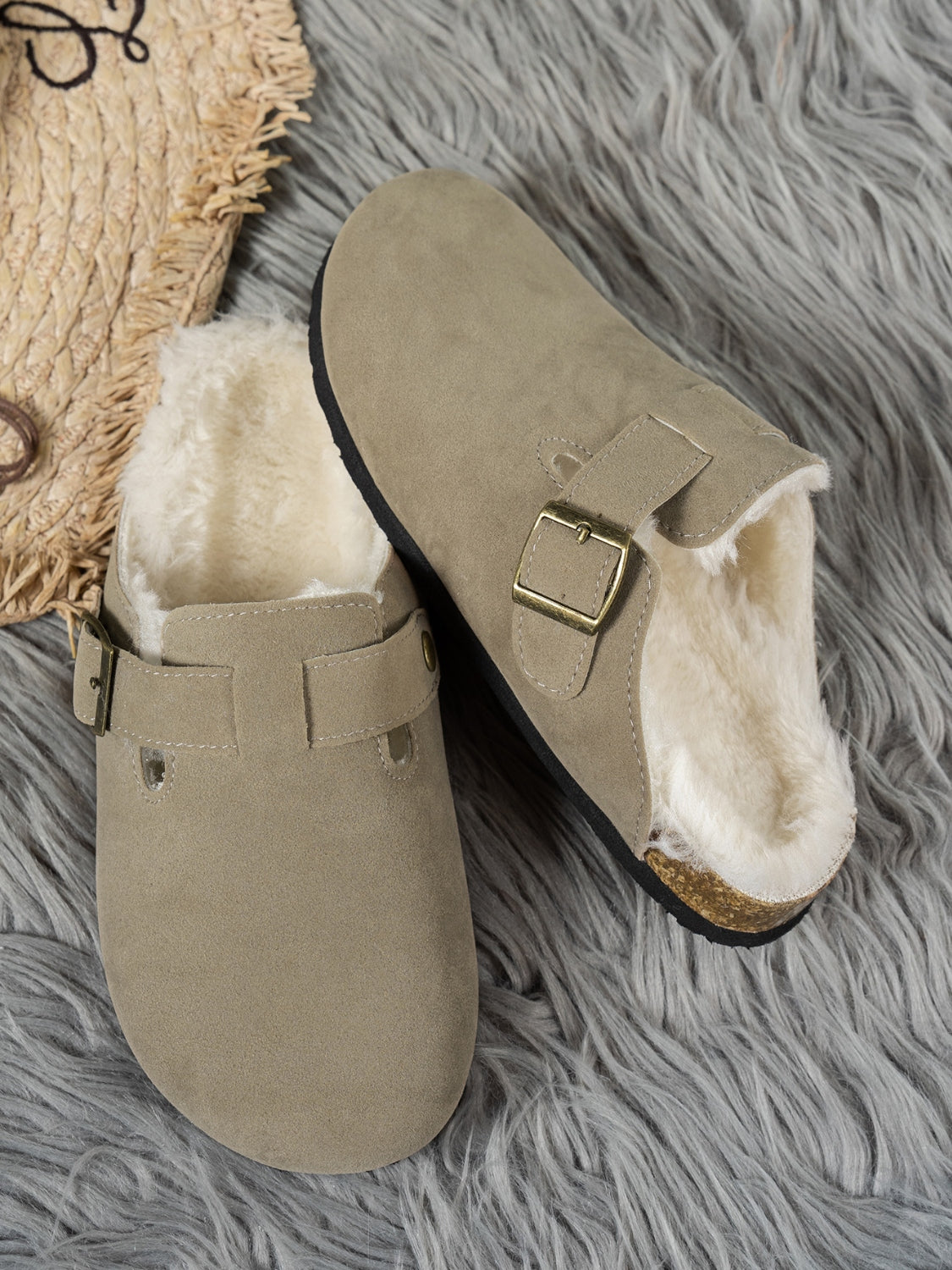 Suede round toe slippers with faux fur lining and rubber sole.