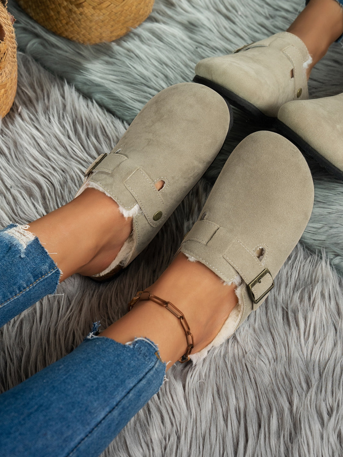 Suede round toe slippers with faux fur lining and rubber sole.