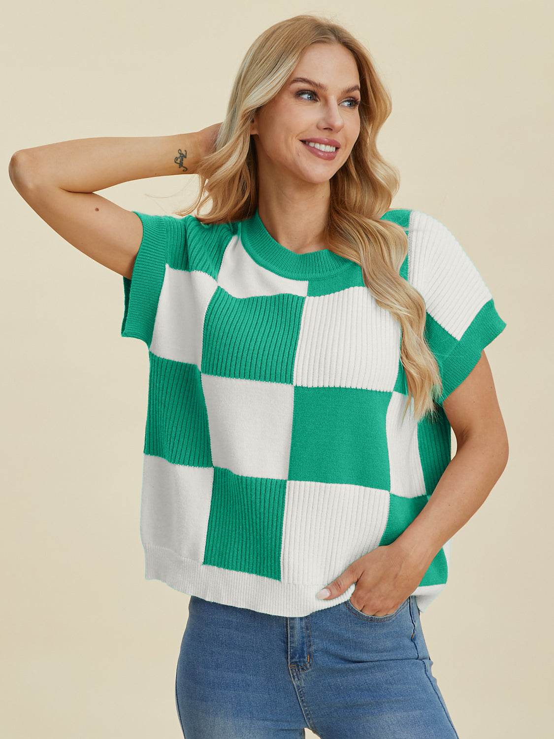 Checkered round neck short sleeve sweater in green and white.