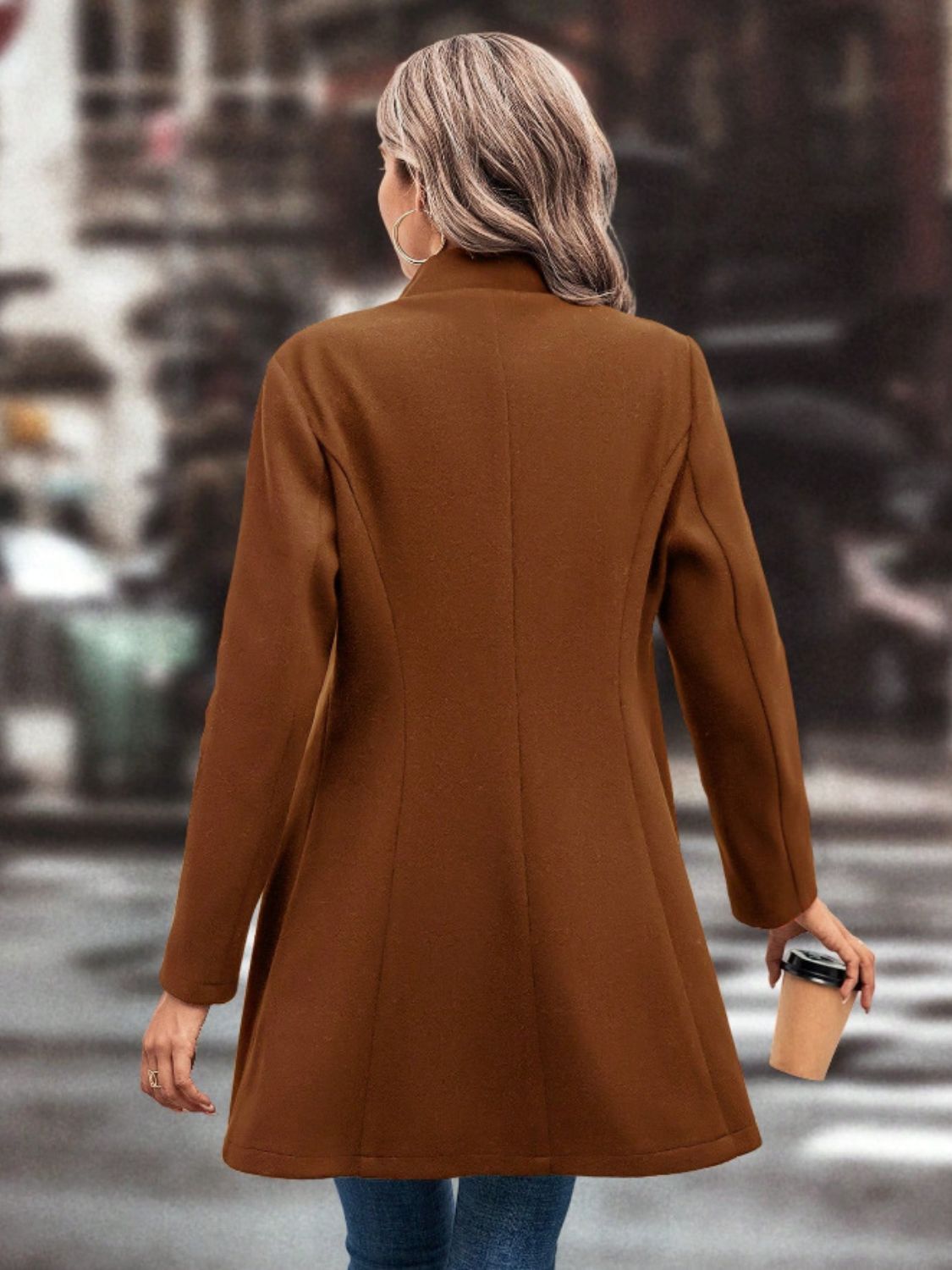 Collared neck button up long sleeve coat in brown, worn by a person holding a coffee cup.