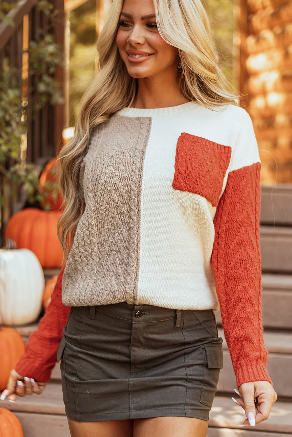 Color block round neck long sleeve sweater with pocket feature.