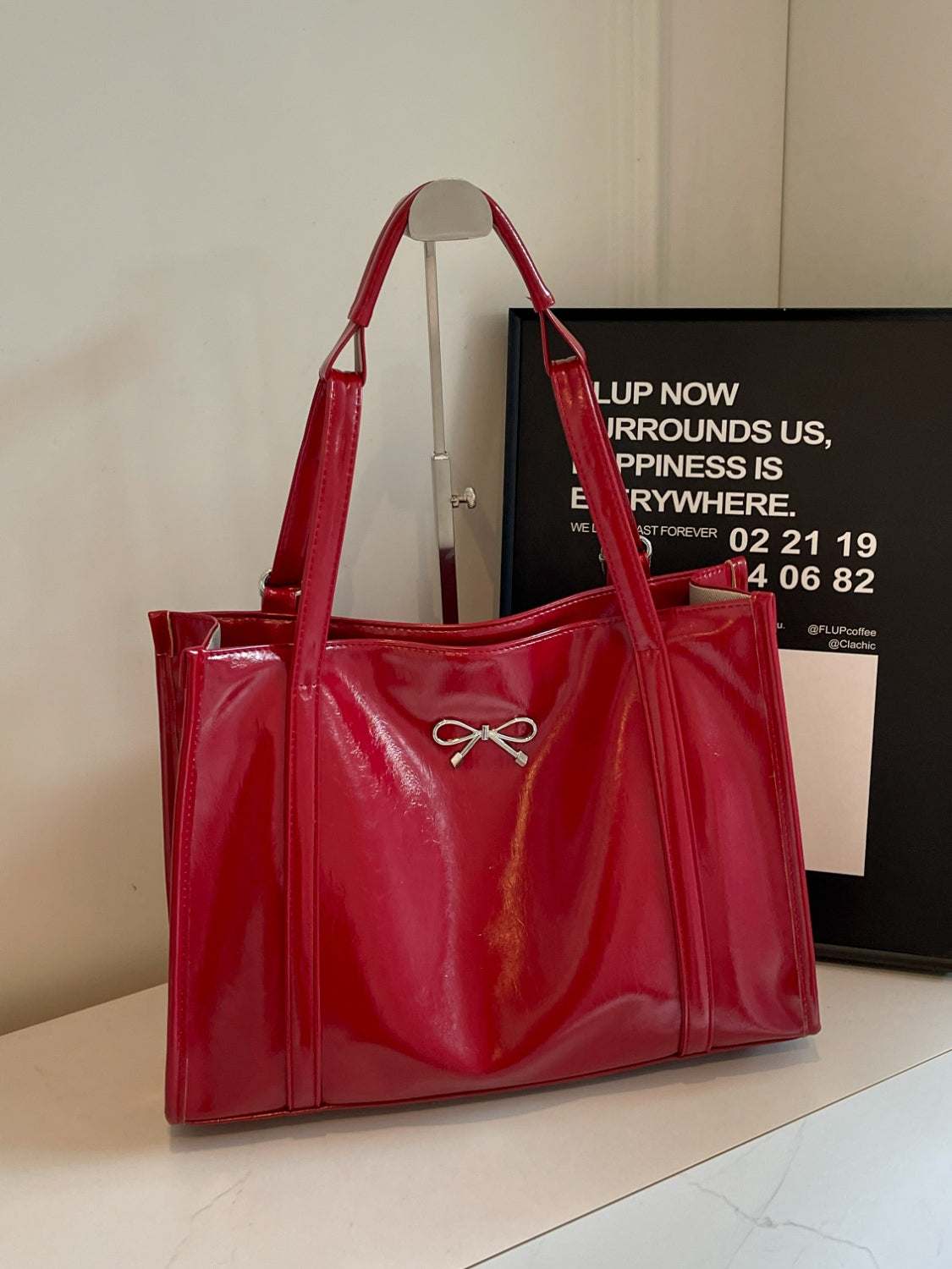 Red PU leather bow shoulder bag with spacious design, ideal for daily essentials.