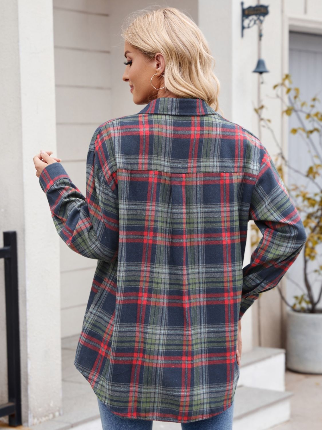 Woman wearing Mandy Plaid Button Up Long Sleeve Shirt in red and green checks, outdoors.