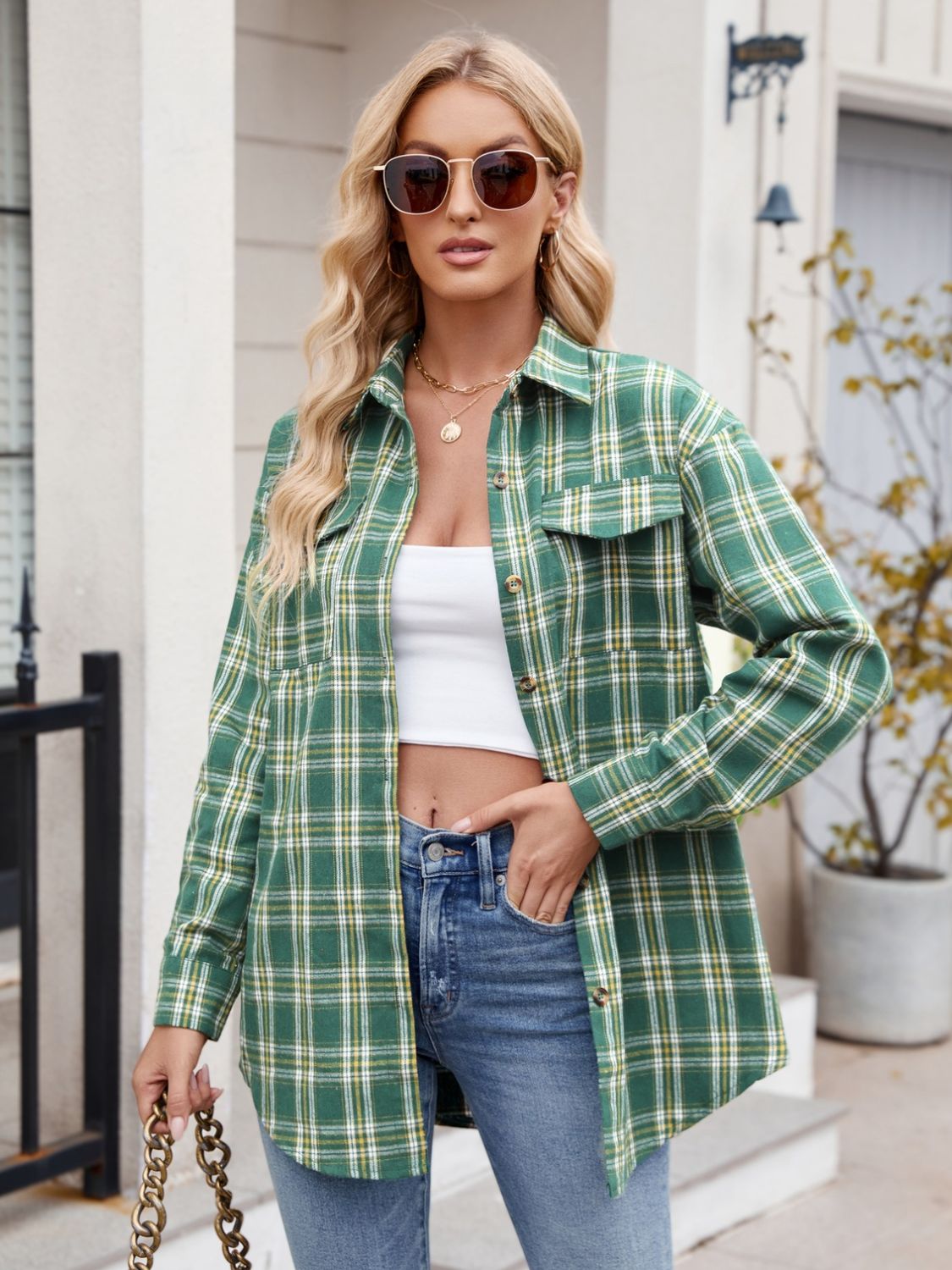 Green plaid button-up long sleeve shirt with pocket, worn casually with jeans.