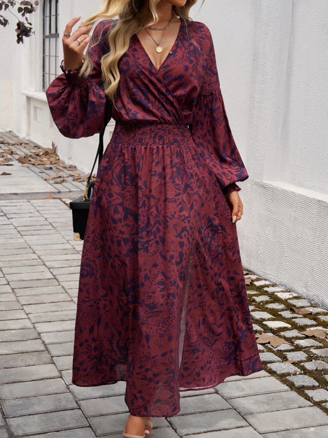 Split printed surplice long sleeve midi dress with smocked waist and opaque material.