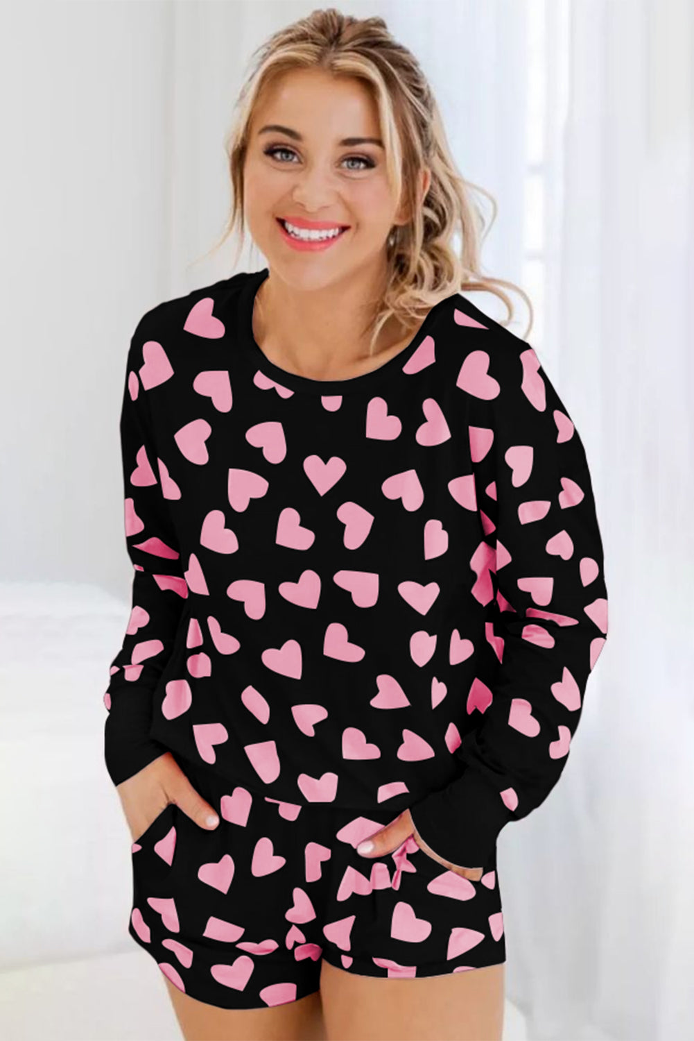 Heart Print Long Sleeve Top and Shorts Lounge Set with pink heart pattern on black fabric.