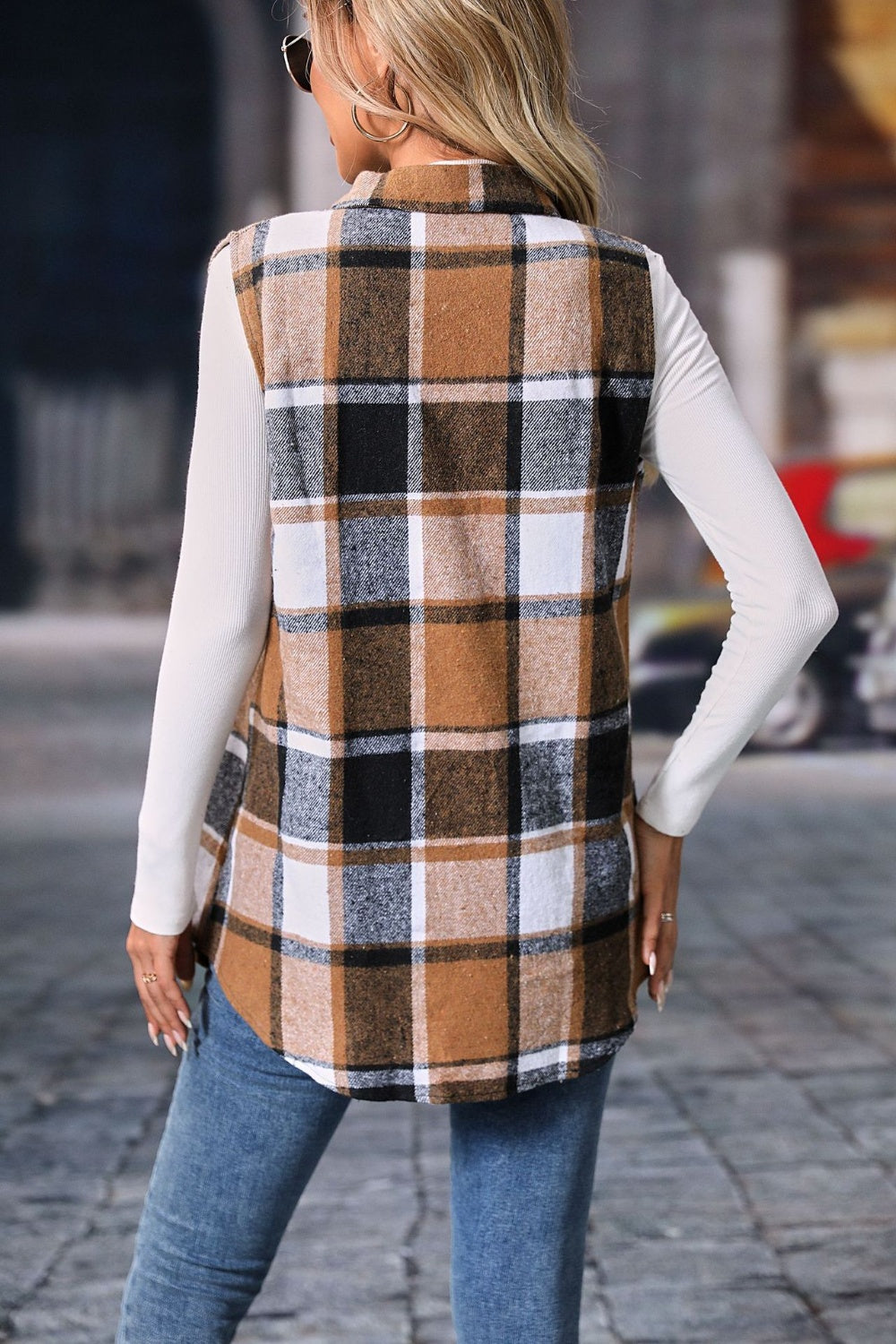 Plaid button-up vest coat with brown, black, and white checkered pattern.