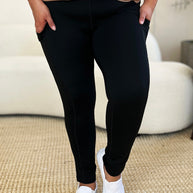 Wide waistband sports leggings in black, featuring a stretchy nylon-spandex blend, perfect for fitness activities.