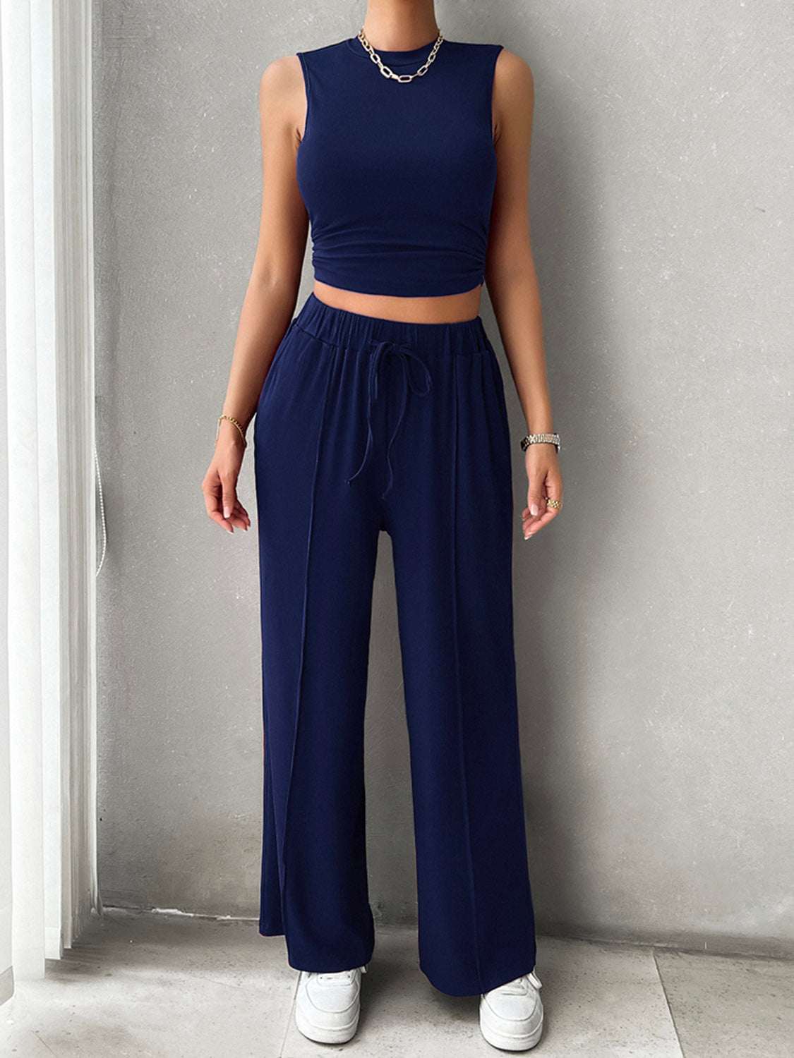 Sleeveless mock neck top and drawstring pants set in navy blue.