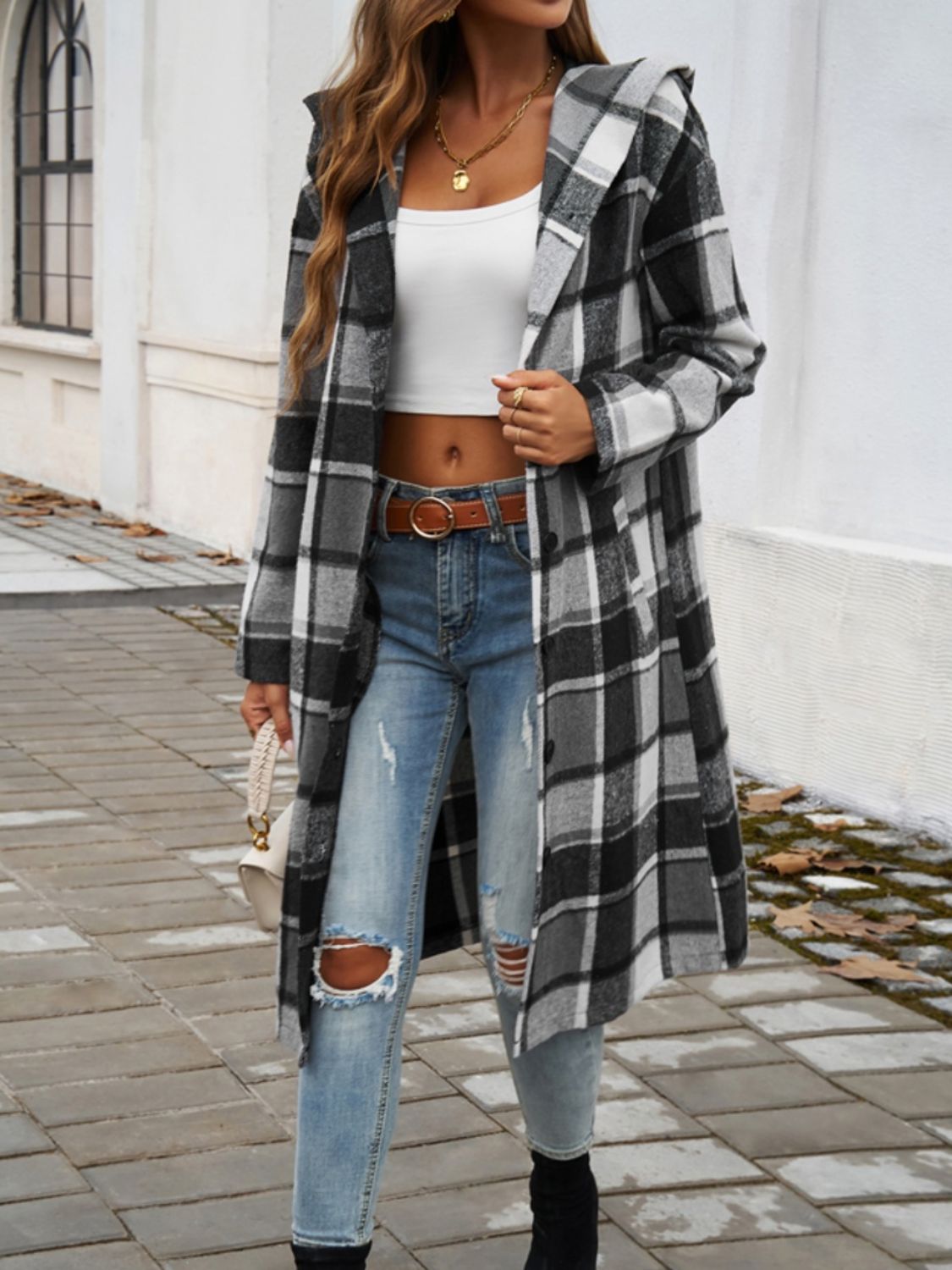 Plaid long sleeve hooded coat with buttoned and pocketed design, worn over casual outfit.