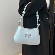 Small Bow PU Leather Knotted Strap Handbag in white carried by a woman.