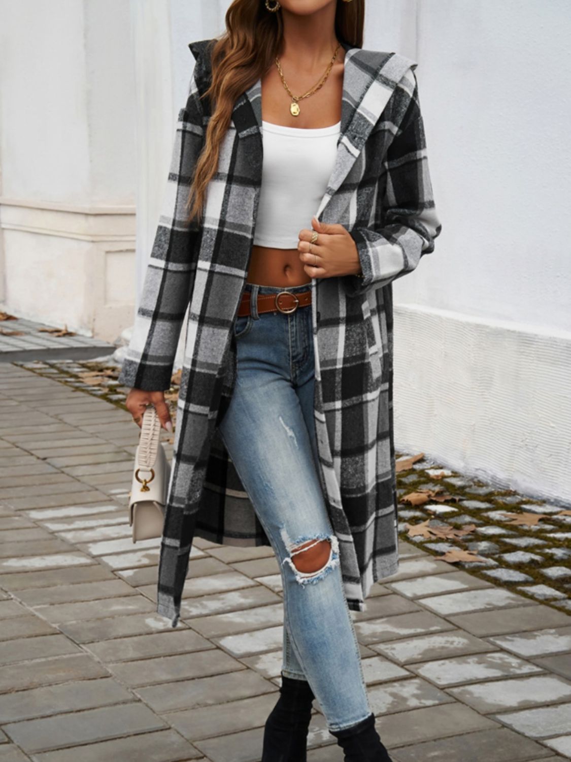 Plaid long sleeve hooded coat with button closure and pockets.