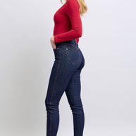 Judy Blue skinny jeans with heart-shaped back pockets, worn with a red top.