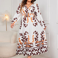 Plus size printed surplice flounce sleeve dress with ruffled design.