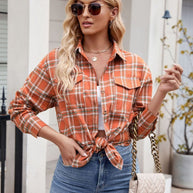 Woman wearing Mandy Plaid Button Up Long Sleeve Shirt with sunglasses and jeans, holding a quilted purse.