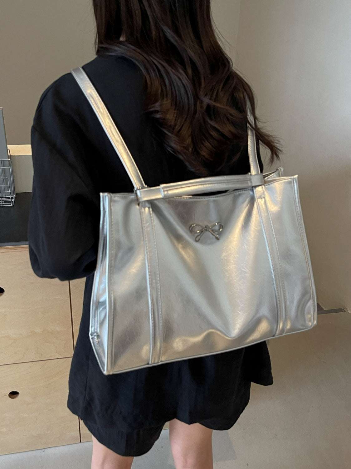 PU leather bow shoulder bag in silver with spacious design.