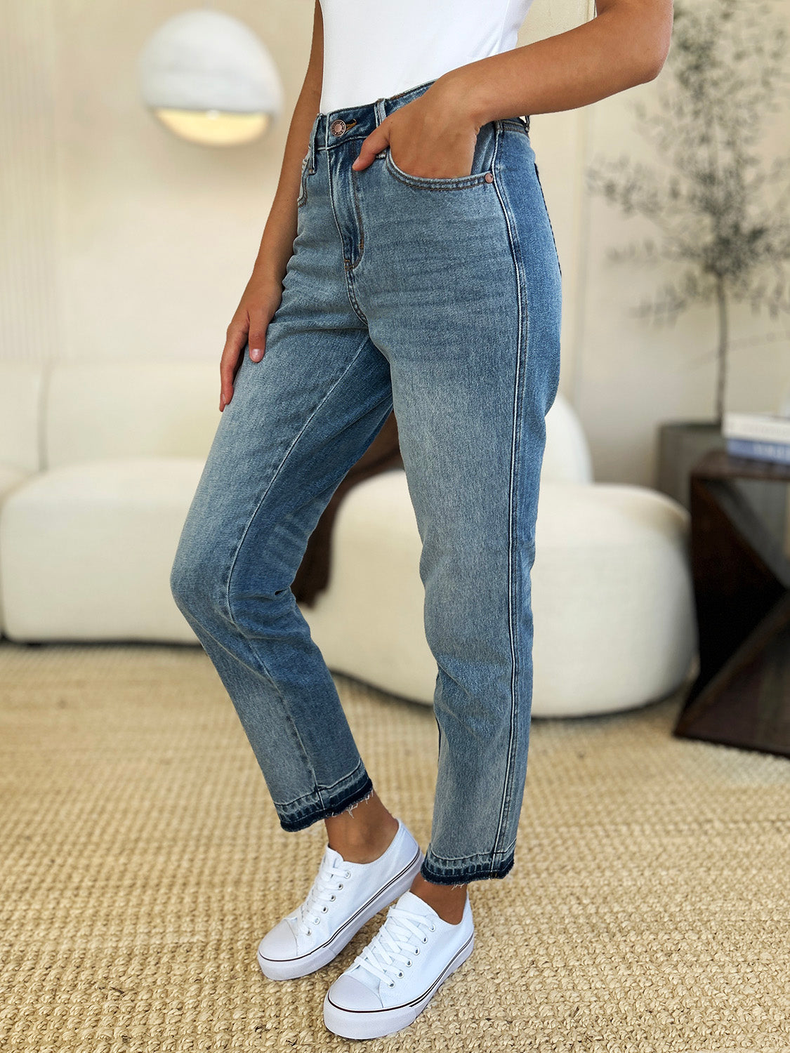 Judy Blue Full Size Mid Rise Rigid Magic Release Hem Jeans worn casually with white sneakers.