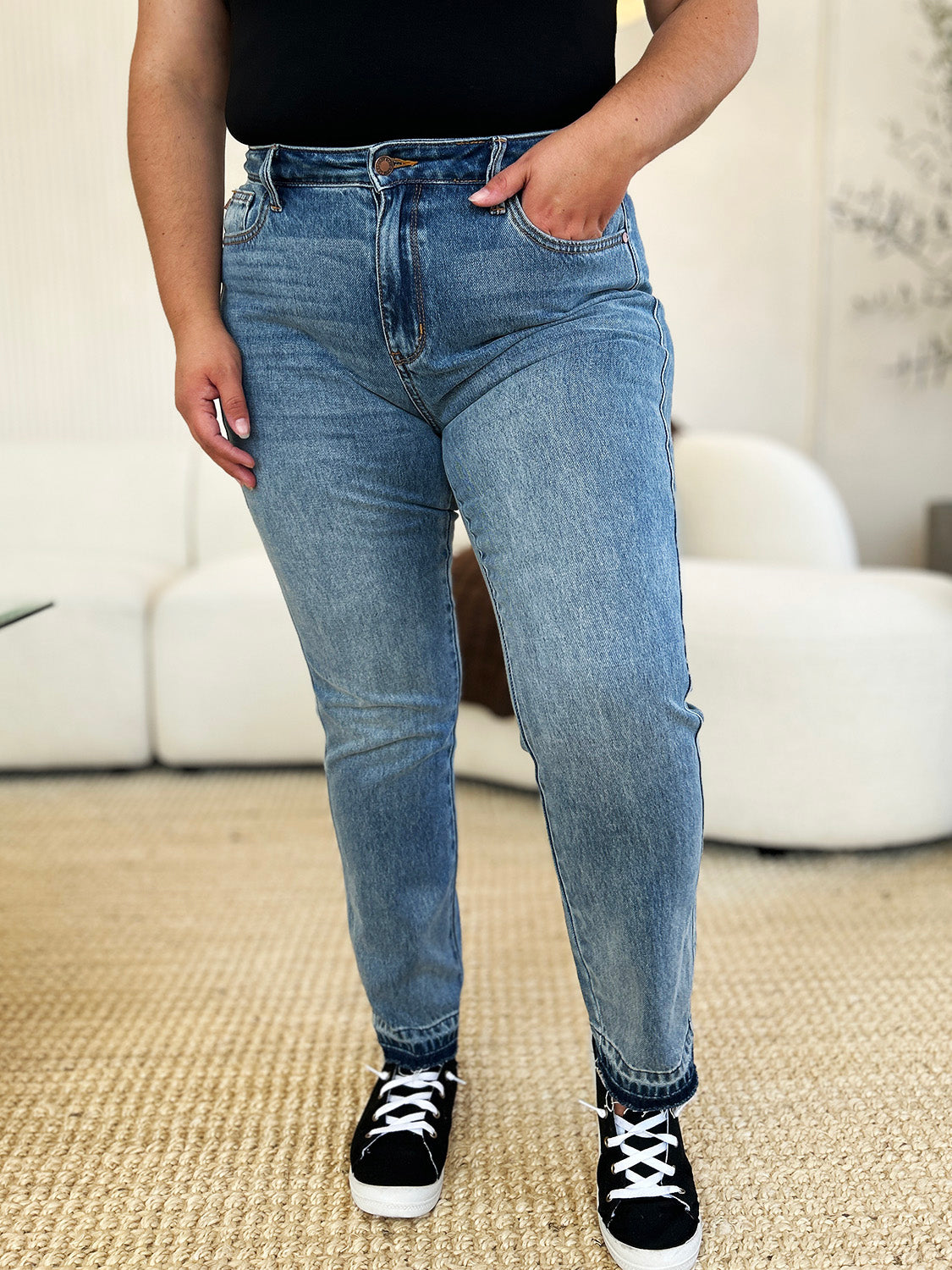 Judy Blue Full Size Mid Rise Rigid Magic Release Hem Jeans in blue, featuring a flattering mid-rise waist and unique hem detail.