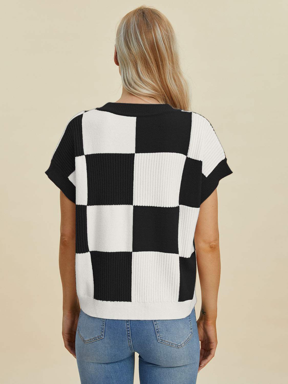 Full size checkered round neck short sleeve sweater in black and white.