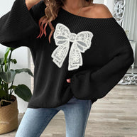 Bow Boat Neck Long Sleeve Sweater with lace bow design, off-shoulder, slightly stretchy knit in black.