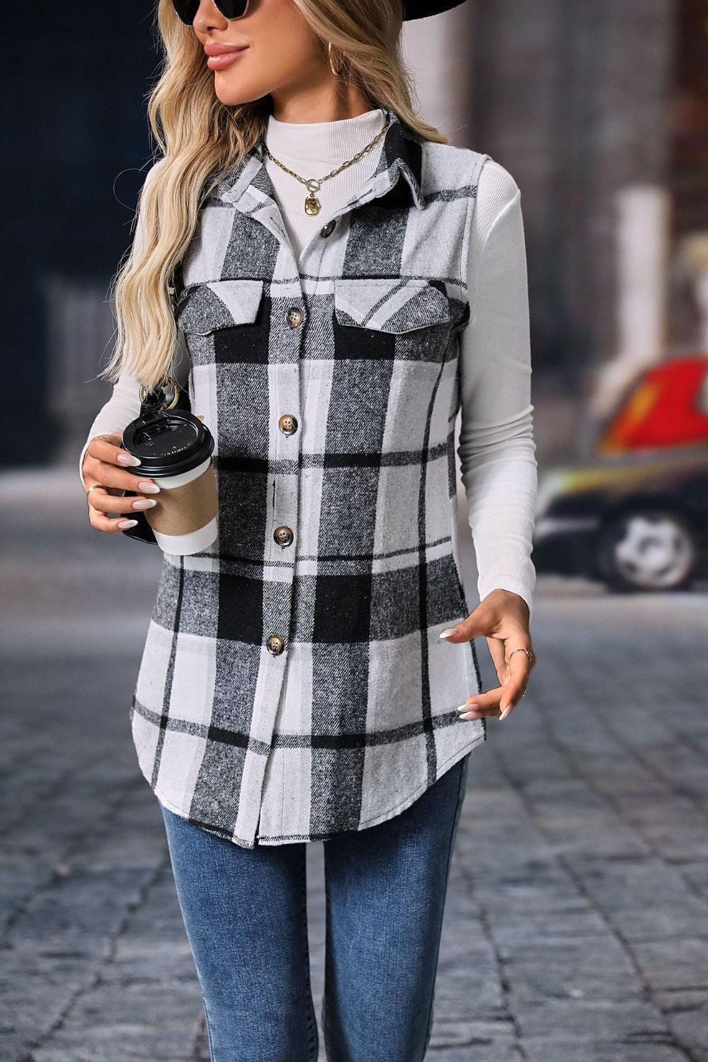 Plaid button-up vest coat with buttoned front and black and white pattern.