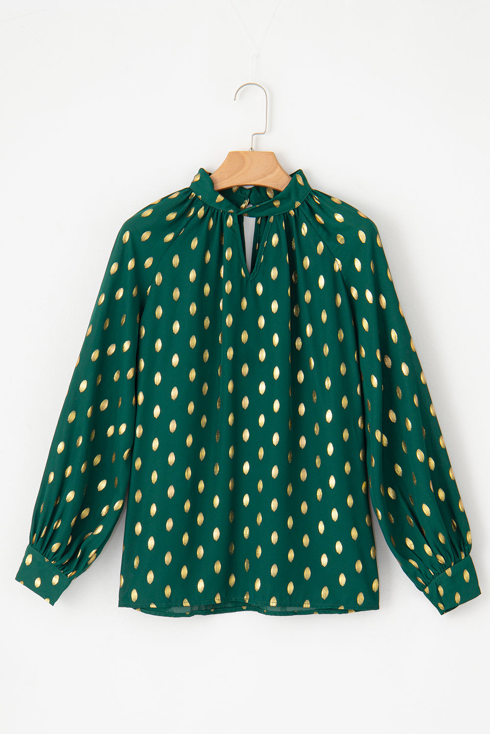 Cutout printed mock neck long sleeve blouse in green with gold pattern.