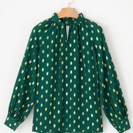 Cutout printed mock neck long sleeve blouse in green with gold pattern.