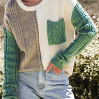 Color block round neck long sleeve sweater with pocket and green, cream, and taupe panels.