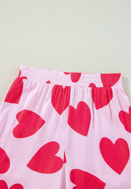 Heart patterned lounge pants with elastic waist, pink and red design.