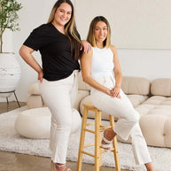 RFM Mini Mia Full Size Tummy Control High Waist Raw Hem Jeans on two women in a stylish setting.