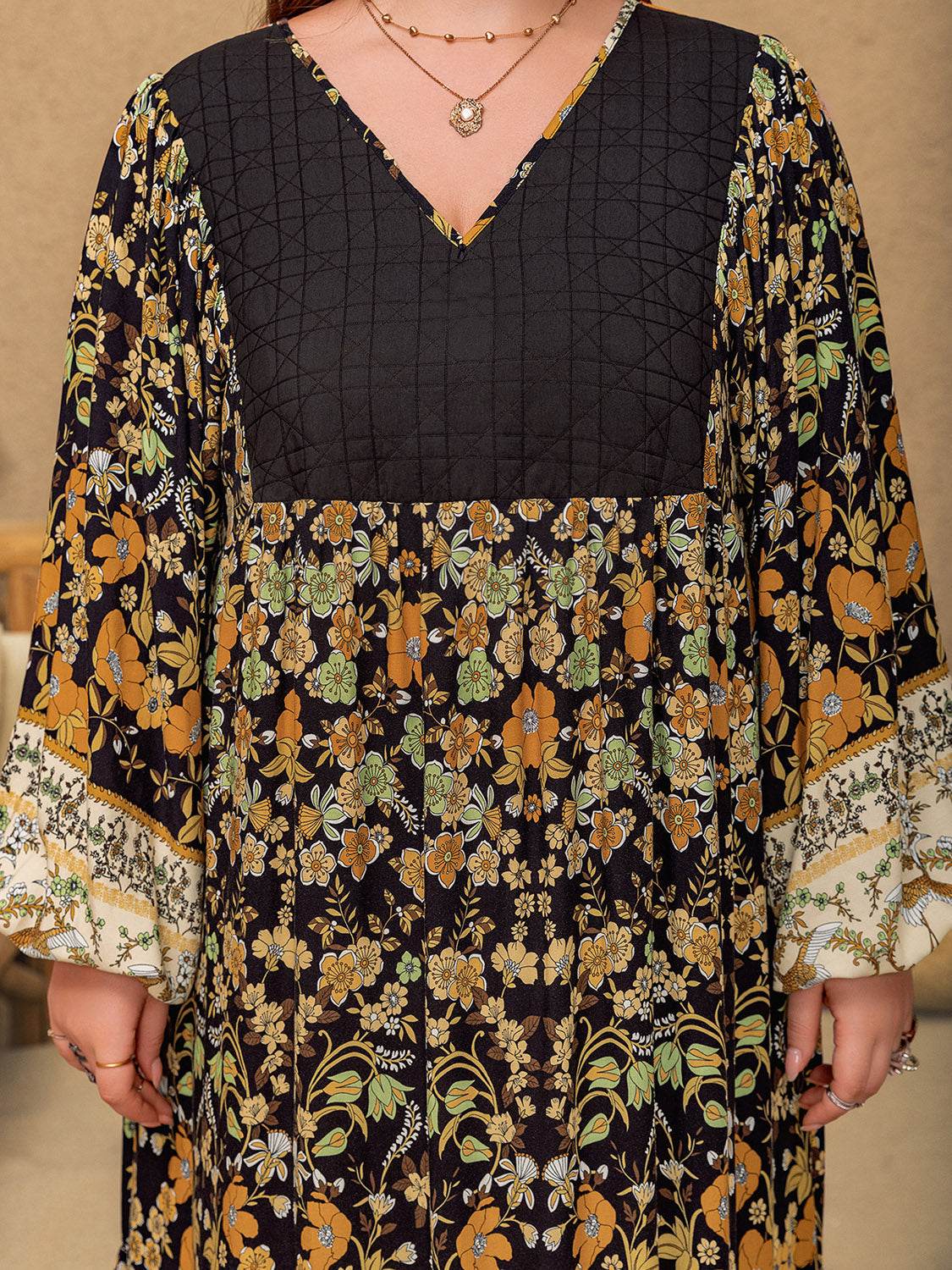 Plus size floral V-neck balloon sleeve midi dress with a patterned design in viscose and polyester.