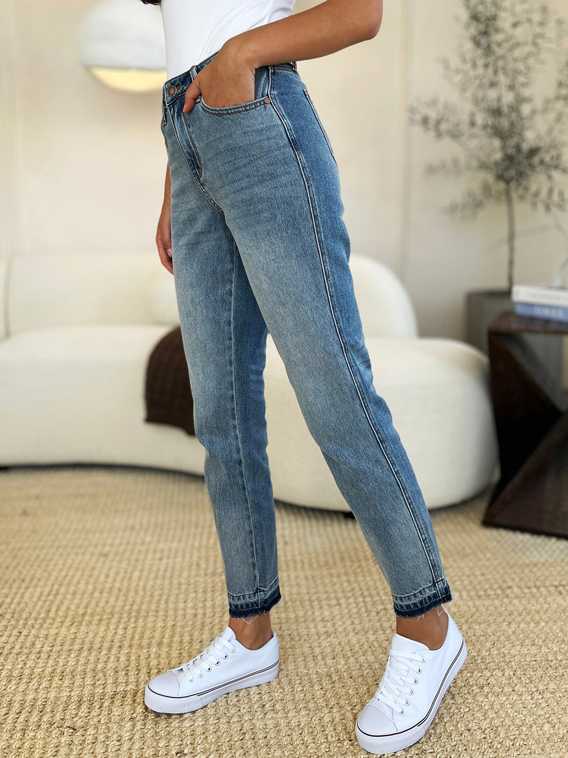 Judy Blue Full Size Mid Rise Rigid Magic Release Hem Jeans styled with white sneakers and casual top.