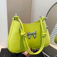 Small bow PU leather knotted strap handbag in lime green color.