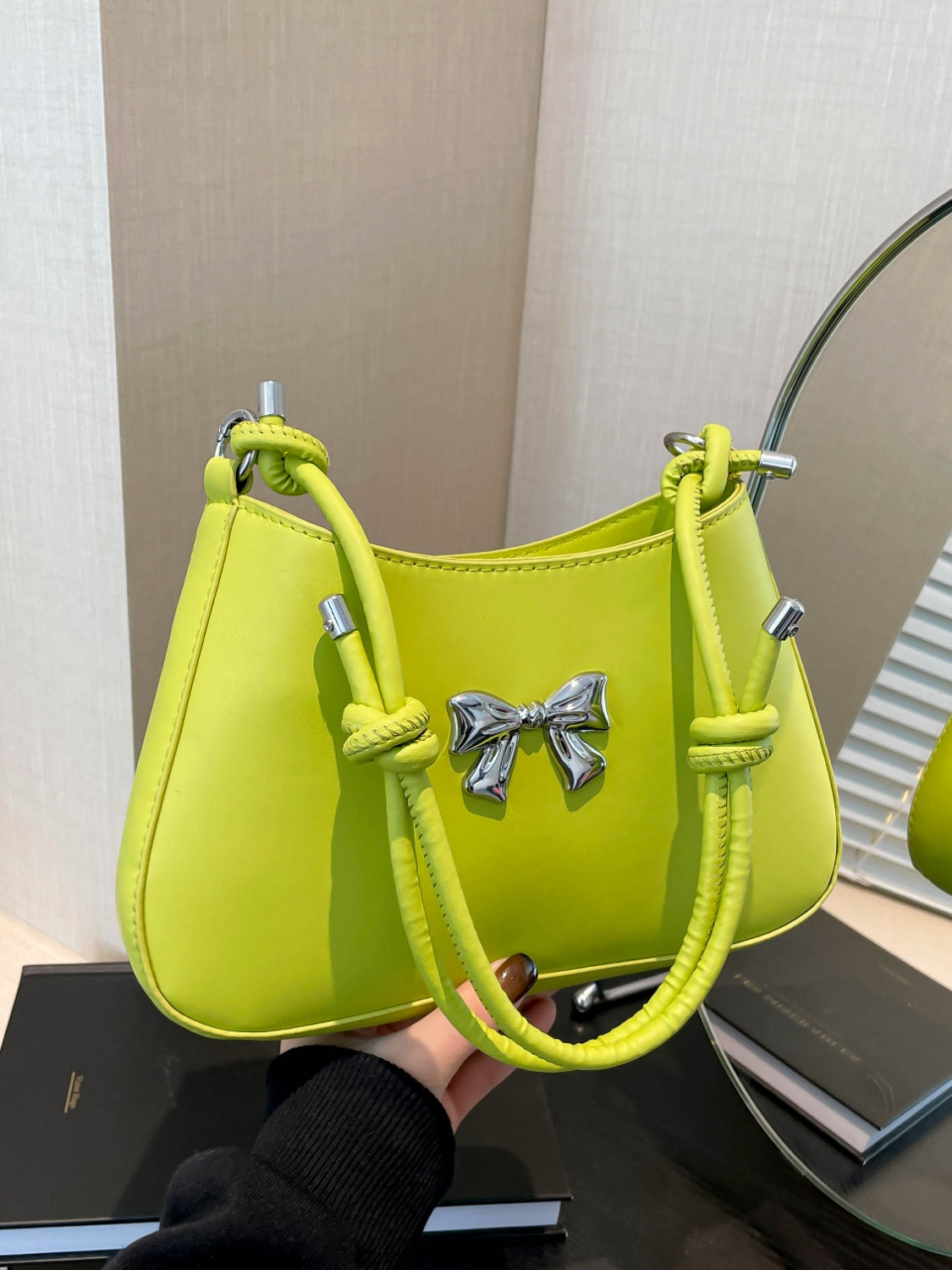 Small bow PU leather knotted strap handbag in lime green color.