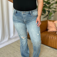 Judy Blue Full Size Medium Rise Tummy Control Destroy Flare Jeans on model, showcasing distressed detailing and flare design.