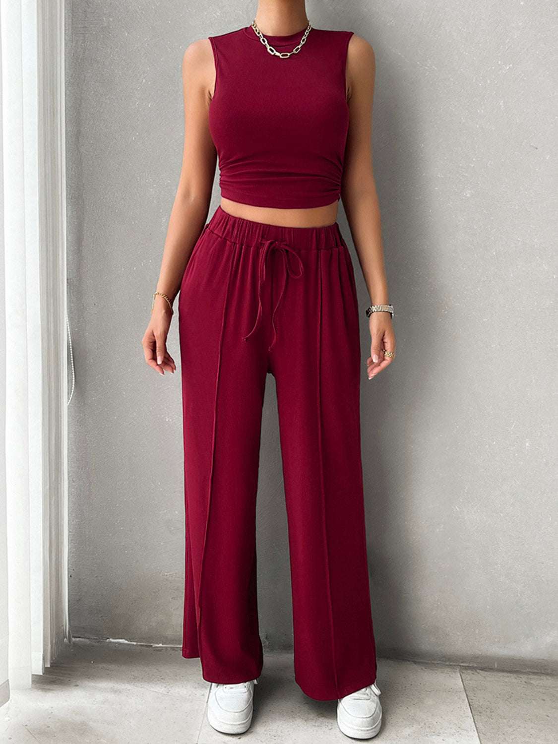 Devine Mock Neck Sleeveless Top and Drawstring Pants Set in red, featuring a pocketed design and drawstring waist.