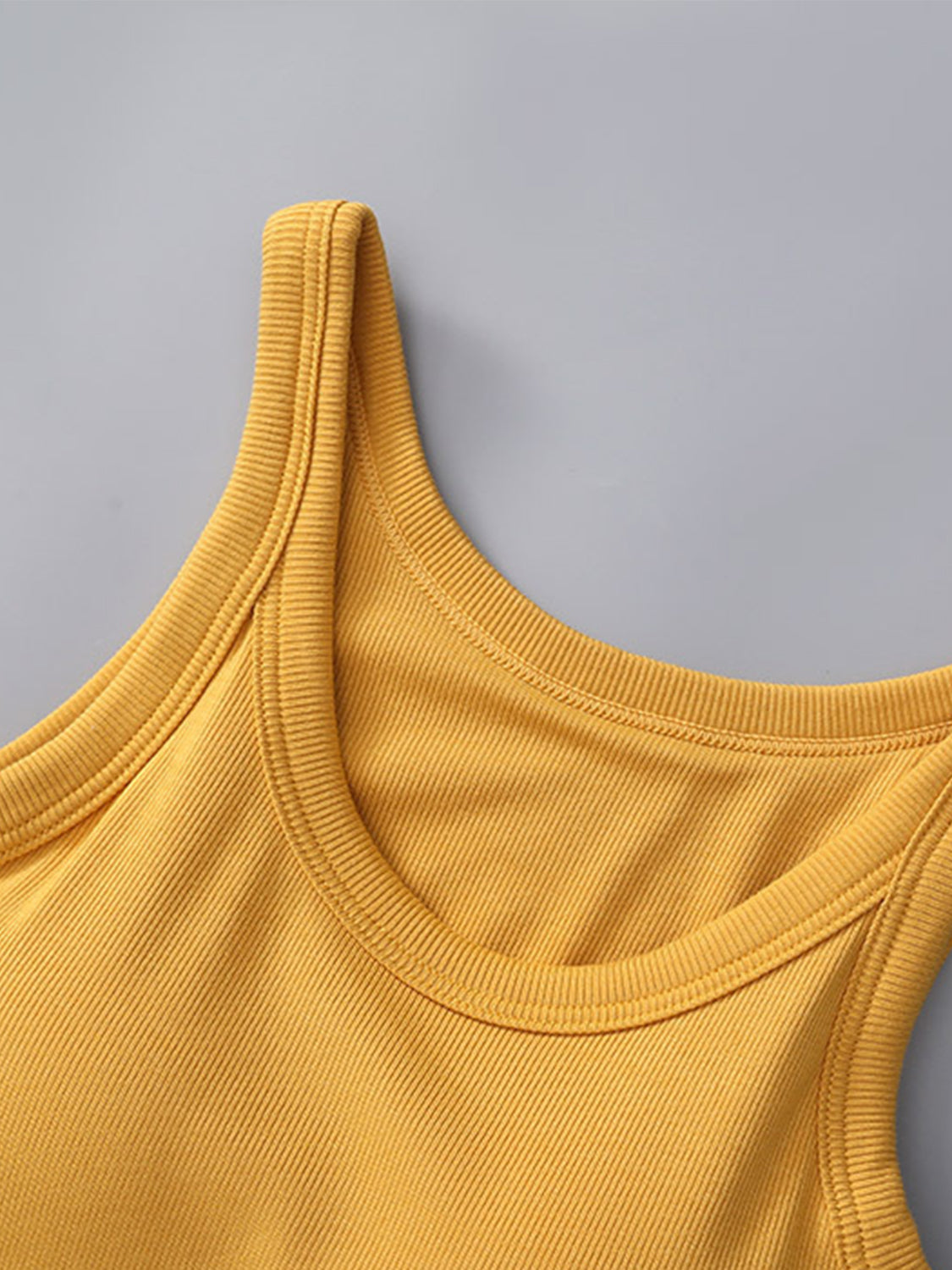 Yellow round neck tank top with built-in bra, featuring basic style and moderate stretch.