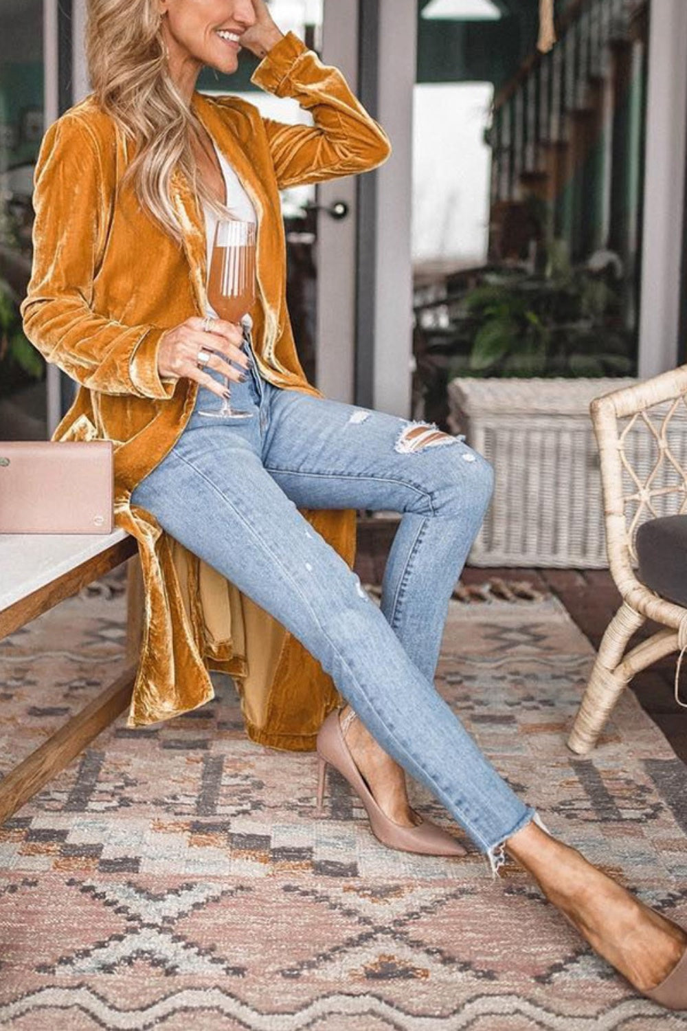 Open front long sleeve coat in mustard color, featuring a slit design, worn with ripped jeans.