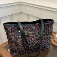 Leopard print polyester tote bag, large size, featuring sturdy black straps.