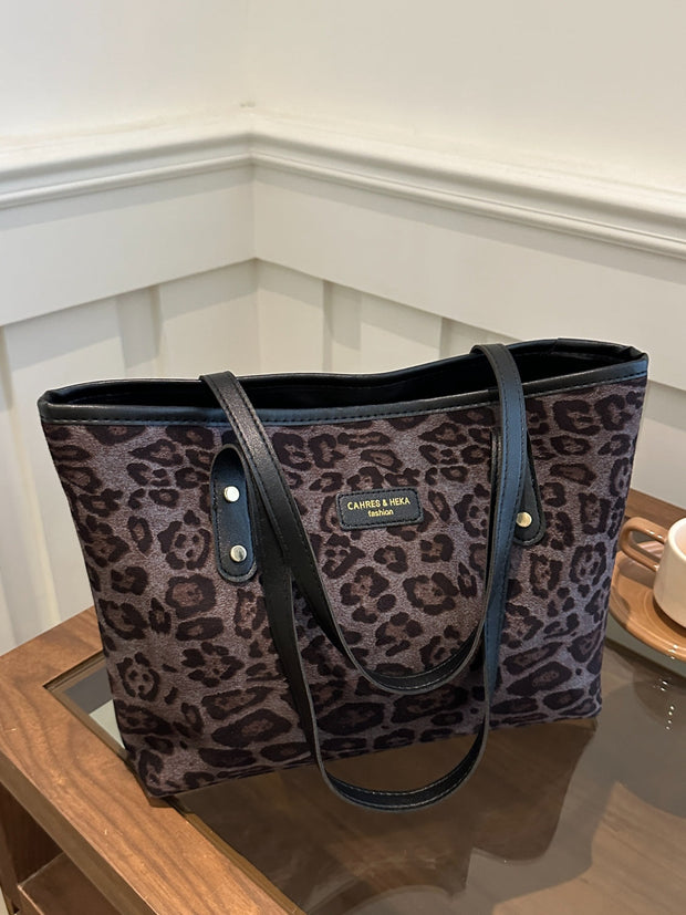 Leopard print polyester tote bag, large size, featuring sturdy black straps.