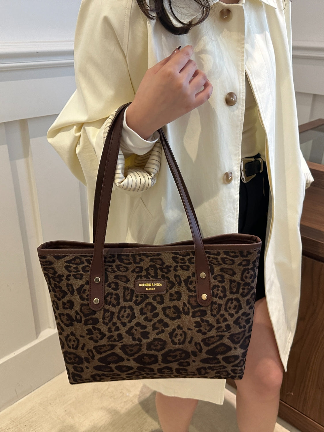 Leopard print polyester tote bag, large size, held by a person.